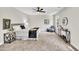 Sunlit main bedroom features carpet flooring, a ceiling fan, and stylish furniture at 2720 Meridian Ct, Dacula, GA 30019