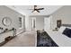 Bright and airy main bedroom features a ceiling fan, carpet flooring, and decorative accents at 2720 Meridian Ct, Dacula, GA 30019