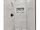 Close up of a modern marble tiled walk-in shower with a black shower head at 2720 Meridian Ct, Dacula, GA 30019