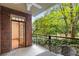 Charming balcony with brick accents, wrought iron railings, and views of the surrounding greenery at 273 12Th Ne St # 210, Atlanta, GA 30309