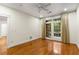 Bright bedroom with wood floors, ceiling fan, and patio doors to balcony at 273 12Th Ne St # 210, Atlanta, GA 30309