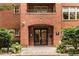 Beautiful brick building featuring a brick entrance and well-manicured landscaping at 273 12Th Ne St # 210, Atlanta, GA 30309