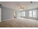 Spacious primary bedroom with carpet, a ceiling fan, and bright windows at 2794 Craig Ct, Marietta, GA 30062