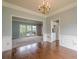 Hardwood dining room with chandelier, wainscoting, and access to other spaces, perfect for hosting and entertaining at 2794 Craig Ct, Marietta, GA 30062