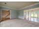 Spacious living room with carpeting, showcasing an open layout, neutral colors, and access to the dining area at 2794 Craig Ct, Marietta, GA 30062