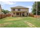 Expansive backyard featuring a covered patio and lush green lawn, perfect for outdoor enjoyment at 3586 Maple Hill Rd, Stonecrest, GA 30038
