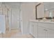 Bathroom featuring double sinks, walk in shower with glass door and beige tile flooring at 3586 Maple Hill Rd, Stonecrest, GA 30038