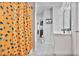 Upstairs bathroom with fun leopard print shower curtain, open shelving and long mirror at 3586 Maple Hill Rd, Stonecrest, GA 30038