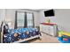 Bedroom featuring neutral paint, carpet, double window, tv, dresser, a bed with space themed bedding at 3586 Maple Hill Rd, Stonecrest, GA 30038