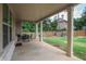 A covered patio with outdoor seating overlooking a spacious backyard and wooden fence at 3586 Maple Hill Rd, Stonecrest, GA 30038