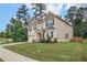 Attractive two-story home with a well-manicured lawn and three-car garage at 3586 Maple Hill Rd, Stonecrest, GA 30038