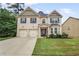 Charming two-story brick home with a well-manicured lawn and a two-car garage at 3586 Maple Hill Rd, Stonecrest, GA 30038