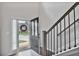 Welcoming entryway featuring a dark front door, staircase, and sidelight window at 3586 Maple Hill Rd, Stonecrest, GA 30038