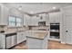 Modern kitchen with granite countertops, stainless steel appliances, and white cabinetry at 3586 Maple Hill Rd, Stonecrest, GA 30038
