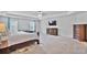 Spacious main bedroom featuring tray ceiling, carpet, ample natural light, and neutral walls at 3586 Maple Hill Rd, Stonecrest, GA 30038