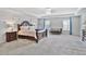 Spacious main bedroom featuring tray ceiling, carpet, ample natural light, and neutral walls and lots of furniture at 3586 Maple Hill Rd, Stonecrest, GA 30038