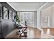 Bright office space featuring a bay window, dark accent wall, and hardwood flooring at 3586 Maple Hill Rd, Stonecrest, GA 30038