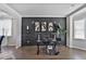 Modern office with dark accent wall, sleek desk, and bright windows at 3586 Maple Hill Rd, Stonecrest, GA 30038