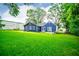 The backyard features a flat and well-manicured lawn, patio, and mature shade trees at 6391 Katherine St, Douglasville, GA 30134