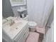 A compact bathroom with a sink, toilet, and shower featuring a white shower curtain at 6391 Katherine St, Douglasville, GA 30134