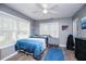 Bright bedroom featuring a modern ceiling fan, a large window, and a comfortable bed at 6391 Katherine St, Douglasville, GA 30134