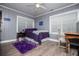 Bedroom featuring two windows and a ceiling fan with a stylish and comfortable bed at 6391 Katherine St, Douglasville, GA 30134