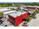 An aerial shot showcasing the exterior of a red brick building in a quaint, walkable town with shops and restaurants at 6391 Katherine St, Douglasville, GA 30134