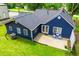 Aerial view of a blue home featuring a well manicured lawn, patio, and mature trees at 6391 Katherine St, Douglasville, GA 30134