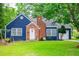 Charming blue home with a brick chimney and a well-manicured front yard at 6391 Katherine St, Douglasville, GA 30134