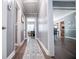 Long hallway with wood-look floors leading to other rooms in the house and neutral paint at 6391 Katherine St, Douglasville, GA 30134