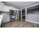 Modern kitchen with stainless steel appliances and light gray cabinetry at 6391 Katherine St, Douglasville, GA 30134