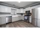 Well lit eat-in kitchen featuring stainless steel appliances, white cabinets, and a window overlooking the yard at 6391 Katherine St, Douglasville, GA 30134