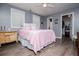 Comfortable bedroom featuring a ceiling fan, wood-look floors, and a bright window view at 6391 Katherine St, Douglasville, GA 30134