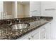 Bathroom vanity with dual sinks, dark granite countertop, and white cabinetry at 2255 Peachtree Ne Rd # 620, Atlanta, GA 30309