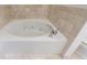 Corner jacuzzi tub with jets and chrome faucet surrounded by tan tiles at 2255 Peachtree Ne Rd # 620, Atlanta, GA 30309