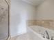 Modern bathroom featuring a walk-in shower, a jacuzzi tub, and neutral tiling at 2255 Peachtree Ne Rd # 620, Atlanta, GA 30309