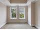 Bright bedroom featuring neutral walls, plush carpet and two windows with a view of lush greenery at 2255 Peachtree Ne Rd # 620, Atlanta, GA 30309