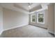 Bedroom featuring tray ceiling, ceiling fan, carpet floors and two windows at 2255 Peachtree Ne Rd # 620, Atlanta, GA 30309