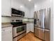 Contemporary kitchen featuring stainless steel appliances, light cabinets, and light stone countertops at 2255 Peachtree Ne Rd # 620, Atlanta, GA 30309
