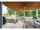 Inviting covered back porch with a porch swing, outdoor seating, and a ceiling fan at 3026 Towne Mill Ave, Canton, GA 30114