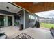 Spacious covered back porch with outdoor seating, a grill, and a view of the backyard at 3026 Towne Mill Ave, Canton, GA 30114