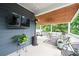 Cozy covered back porch with comfortable seating, ceiling fan, and outdoor television at 3026 Towne Mill Ave, Canton, GA 30114