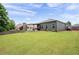 Expansive backyard with lush green grass and mature trees, perfect for outdoor activities at 3026 Towne Mill Ave, Canton, GA 30114