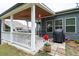 Landscaped backyard featuring a covered porch, a grill, and a well-maintained lawn at 3026 Towne Mill Ave, Canton, GA 30114