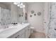 Well-lit bathroom featuring a double sink vanity, white cabinets, and decorative accents at 3026 Towne Mill Ave, Canton, GA 30114