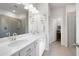 Bathroom with double vanity sinks, a large mirror, and a glass-enclosed shower stall at 3026 Towne Mill Ave, Canton, GA 30114