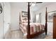 Bright bedroom with a four-poster bed, neutral carpet, and matching wooden furniture at 3026 Towne Mill Ave, Canton, GA 30114