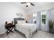 Bedroom with decorative wall art, ceiling fan, natural lighting, and neutral carpeting at 3026 Towne Mill Ave, Canton, GA 30114