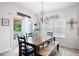Dining area with a wooden table, bench seating, and a decorative chandelier at 3026 Towne Mill Ave, Canton, GA 30114