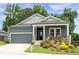 Charming home with a well-manicured lawn, inviting front porch, and neutral paint colors at 3026 Towne Mill Ave, Canton, GA 30114